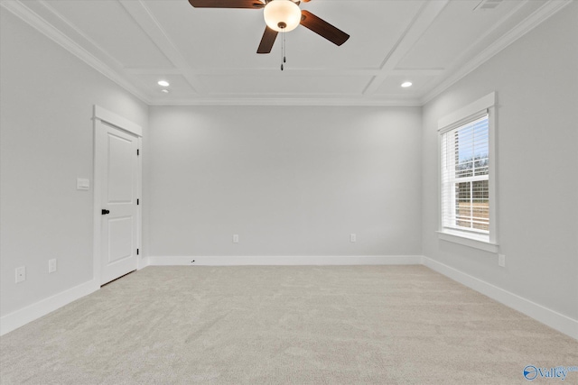 carpeted spare room featuring ceiling fan, crown molding, and coffered ceiling