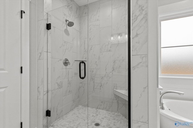 bathroom featuring shower with separate bathtub