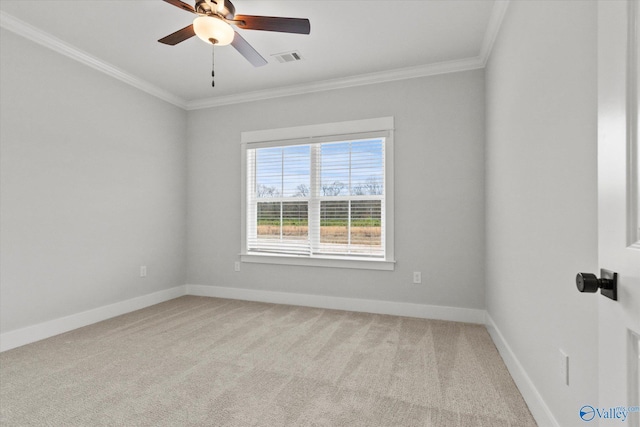 spare room featuring light colored carpet, ceiling fan, and ornamental molding