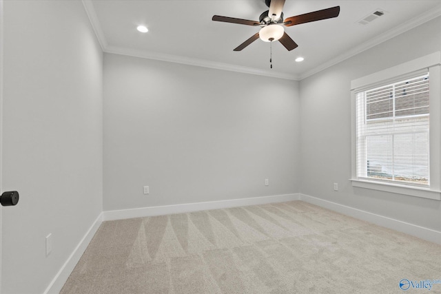 spare room with ornamental molding, light carpet, and a wealth of natural light