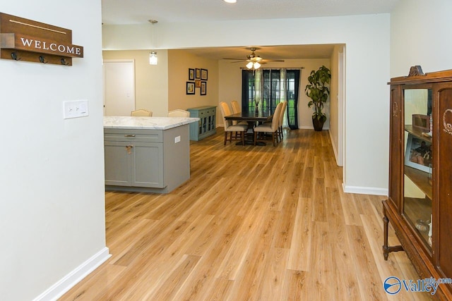 1409 8th Ave SE, Decatur, AL 35601 - kitchen featuring gray cabinets, light wood finished floors, ceiling fan, baseboards, and light stone countertops