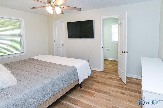 1409 8th Ave SE, Decatur, AL 35601 - bedroom with light wood-type flooring, baseboards, and a ceiling fan