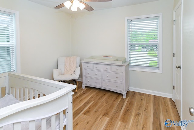 1409 8th Ave SE, Decatur, AL 35601 - bedroom featuring light wood-type flooring, baseboards, and a ceiling fan