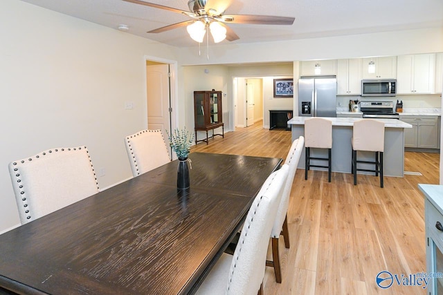 1409 8th Ave SE, Decatur, AL 35601 - dining room with ceiling fan and light wood-style floors