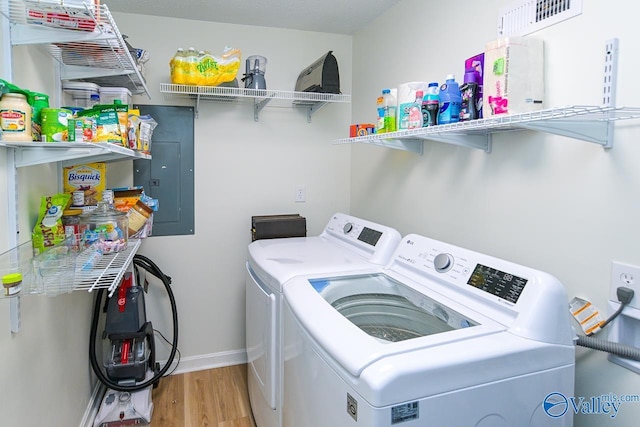 1409 8th Ave SE, Decatur, AL 35601 - washroom featuring washer and dryer, electric panel, wood finished floors, and baseboards