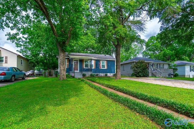 1409 8th Ave SE, Decatur, AL 35601 - view of front of property with covered porch, a front lawn, and driveway