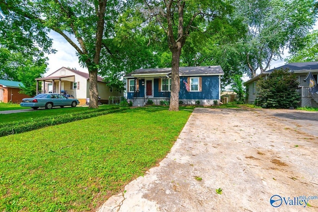 1409 8th Ave SE, Decatur, AL 35601 - view of front of home featuring covered porch, a front yard, and driveway