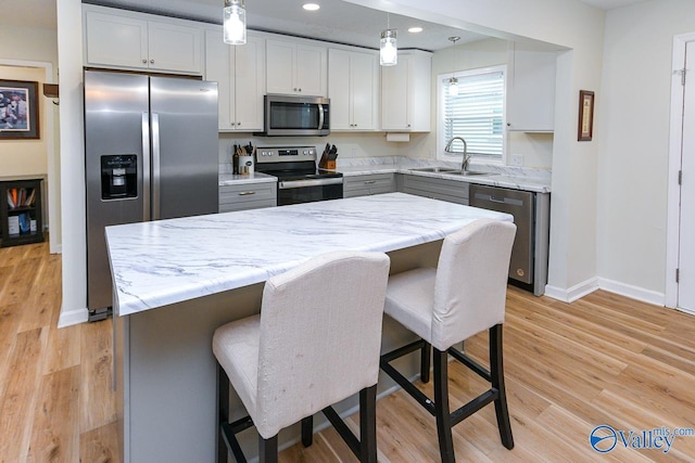 1409 8th Ave SE, Decatur, AL 35601 - kitchen featuring stainless steel appliances, a sink, baseboards, recessed lighting, and light stone countertops