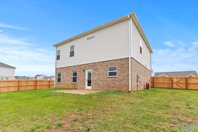18577 Cottontail Ln, Athens, AL 35613 - rear view of property featuring a yard, brick siding, a fenced backyard, and a patio area