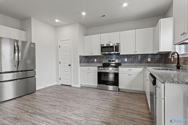 18577 Cottontail Ln, Athens, AL 35613 - kitchen with light stone counters, a sink, tasteful backsplash, and stainless steel appliances