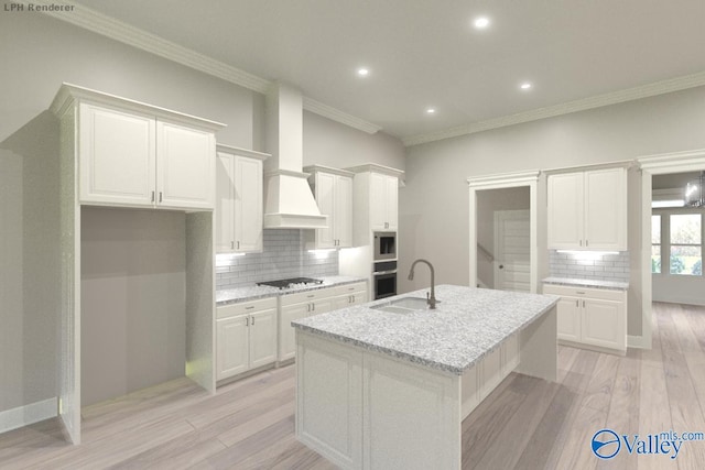 kitchen with black gas stovetop, backsplash, white cabinetry, a kitchen island with sink, and light stone counters