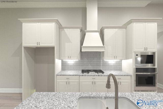 kitchen with light stone countertops, sink, white cabinetry, and gas stovetop