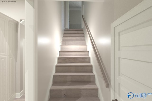 staircase featuring crown molding