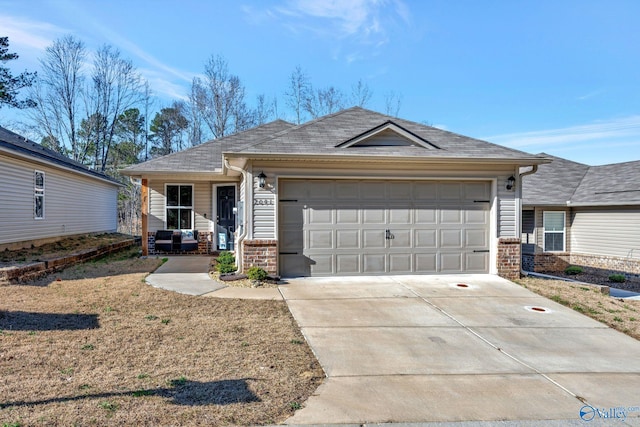 ranch-style home with a garage, brick siding, and driveway