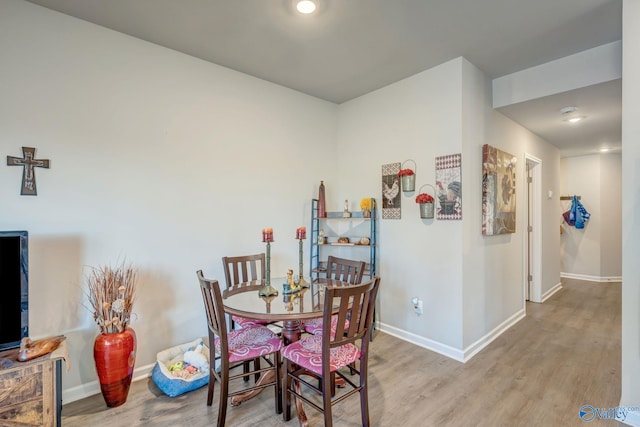 dining space featuring wood finished floors and baseboards