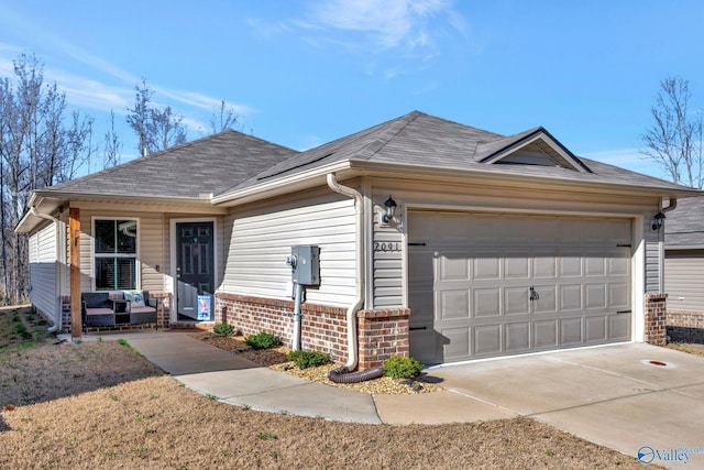 ranch-style home with a porch, roof with shingles, concrete driveway, an attached garage, and brick siding