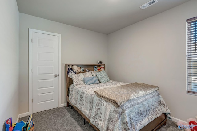 carpeted bedroom with visible vents and baseboards