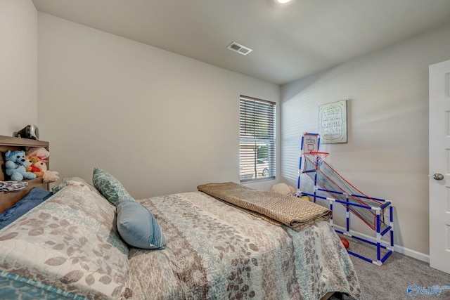 bedroom with visible vents, carpet floors, and baseboards