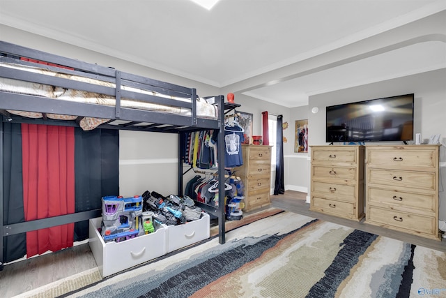 bedroom with hardwood / wood-style floors and ornamental molding