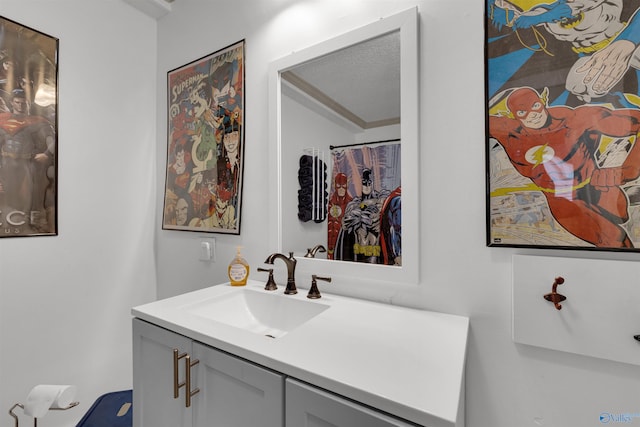 bathroom with a shower with curtain, vanity, and a textured ceiling