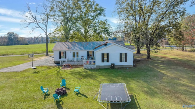 ranch-style home with a wooden deck and a front yard