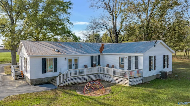 view of front facade with french doors, central AC, a front lawn, and a wooden deck