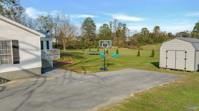 view of patio with a storage shed and a trampoline