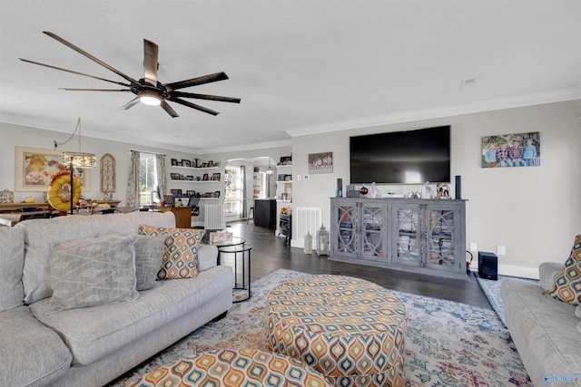 living room with ceiling fan, crown molding, and dark wood-type flooring