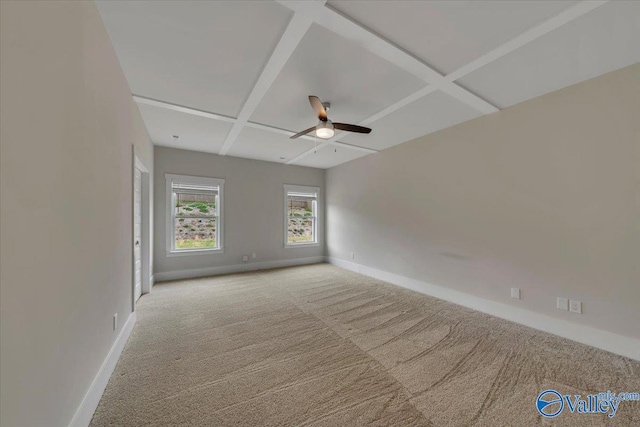 unfurnished room with ceiling fan, light colored carpet, baseboards, and coffered ceiling