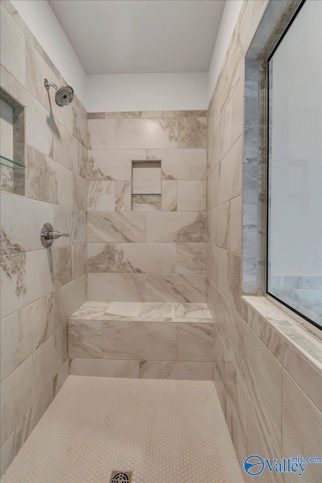 full bath featuring a tile shower