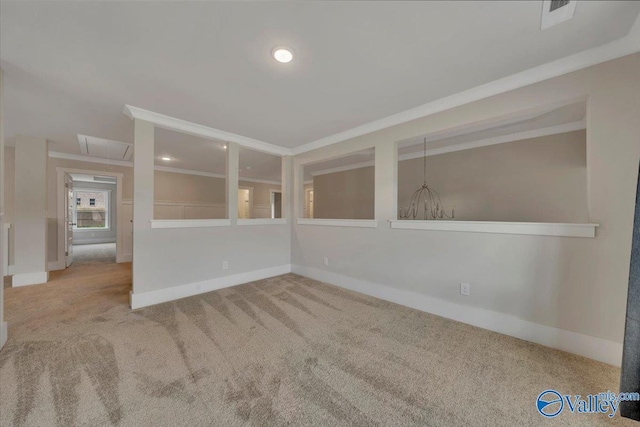 carpeted empty room featuring recessed lighting, attic access, baseboards, and crown molding