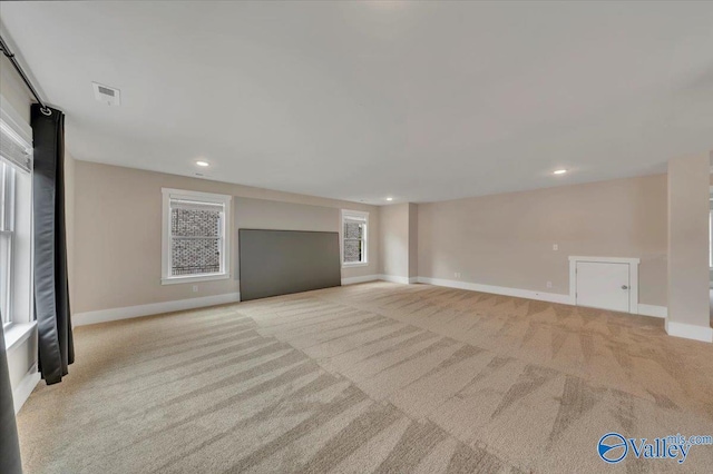 unfurnished living room featuring carpet floors, baseboards, recessed lighting, and visible vents