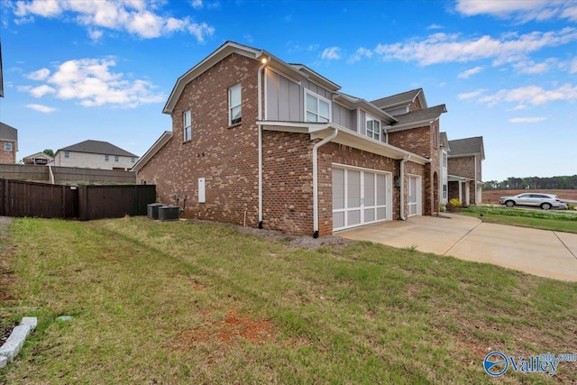 view of property exterior featuring concrete driveway, brick siding, a garage, a yard, and fence