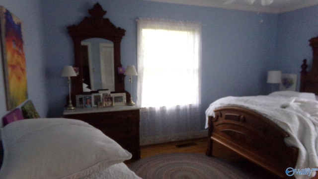 bedroom with wood finished floors and baseboards