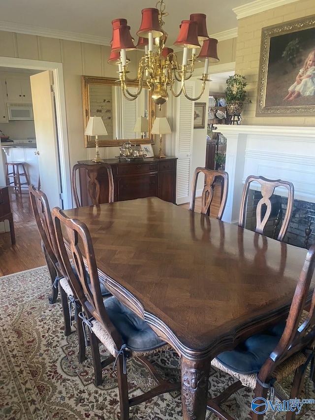 dining room featuring ornamental molding, dark wood finished floors, and an inviting chandelier