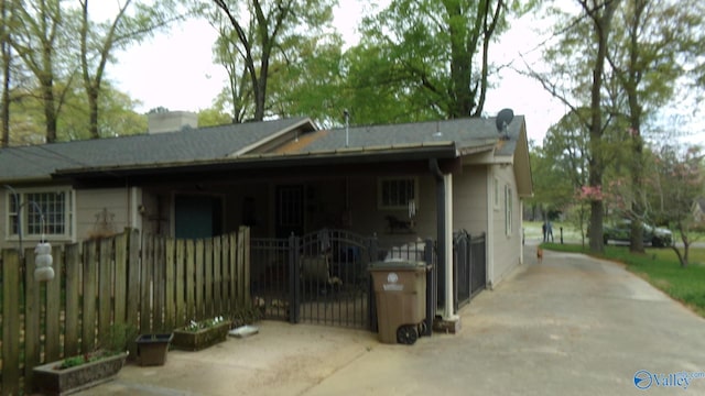 view of property exterior with a gate, fence private yard, and a chimney