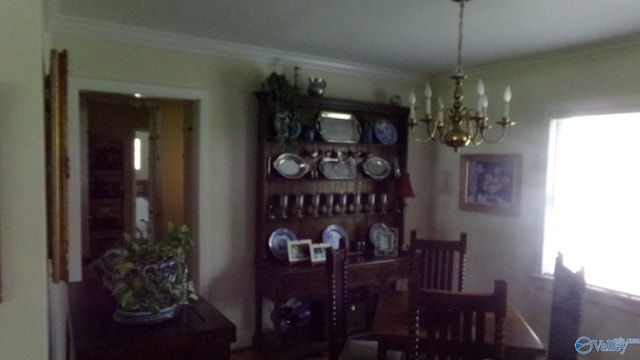 dining space featuring an inviting chandelier and ornamental molding