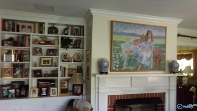 living area with a fireplace and crown molding
