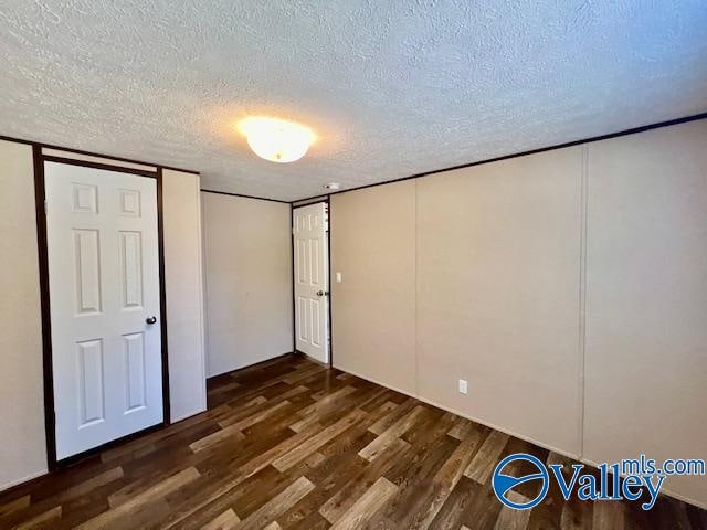 unfurnished bedroom featuring dark hardwood / wood-style floors and a textured ceiling