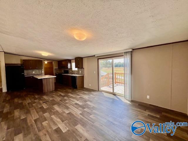 unfurnished living room with dark hardwood / wood-style floors and a textured ceiling