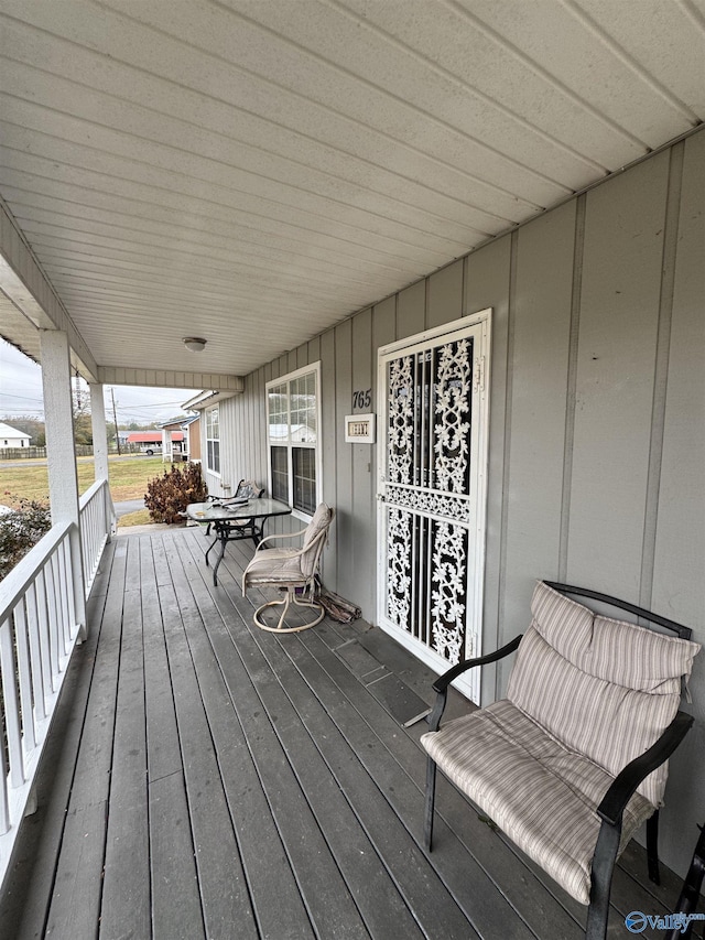 wooden terrace featuring covered porch