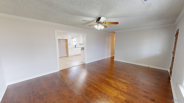 unfurnished room featuring sink, a textured ceiling, ornamental molding, dark hardwood / wood-style flooring, and ceiling fan