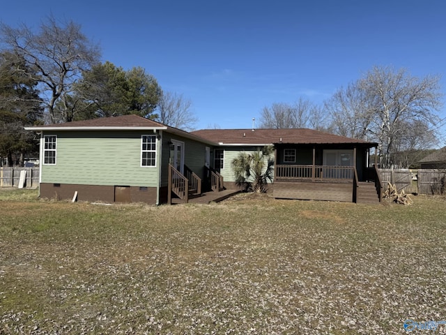 back of house with a lawn