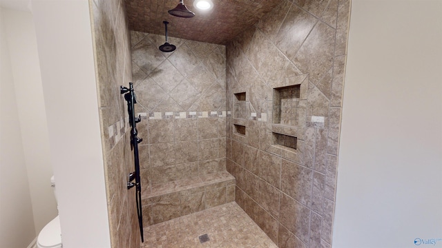 bathroom with toilet and tiled shower