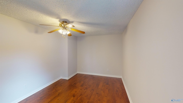 empty room featuring ceiling fan, dark hardwood / wood-style flooring, and a textured ceiling