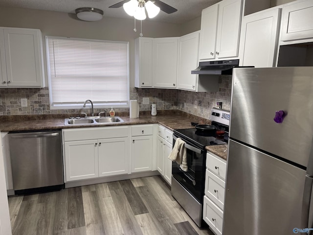 4503 Kenwood Dr, Huntsville, AL 35810 - kitchen with stainless steel appliances, a sink, dark countertops, a ceiling fan, and under cabinet range hood