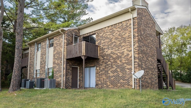 exterior space with a balcony and a lawn