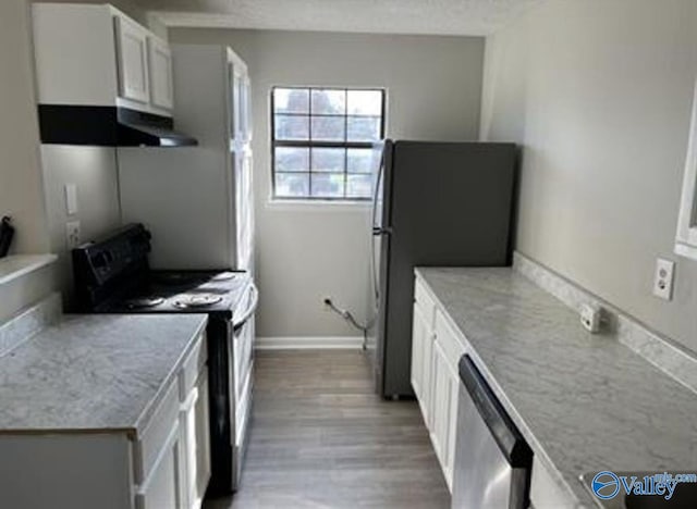 kitchen with white cabinets, a textured ceiling, light wood-type flooring, and black appliances