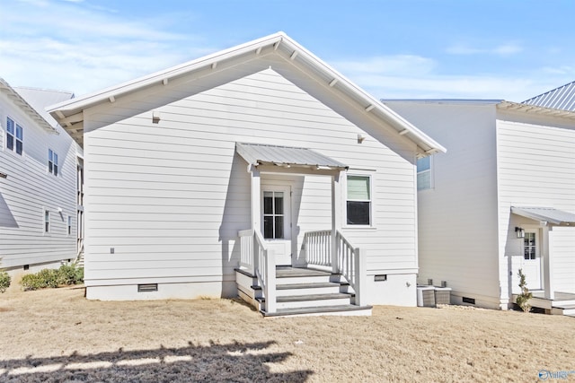 rear view of house featuring crawl space and cooling unit