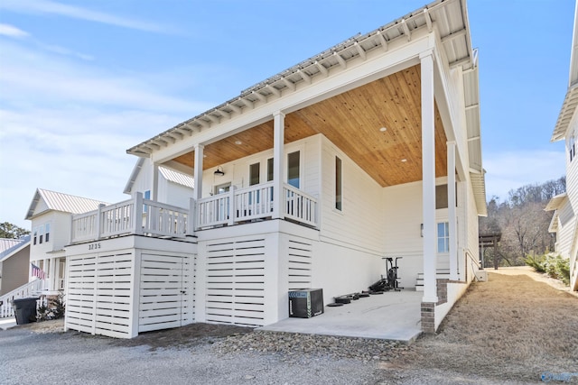 view of side of home with covered porch and central AC unit